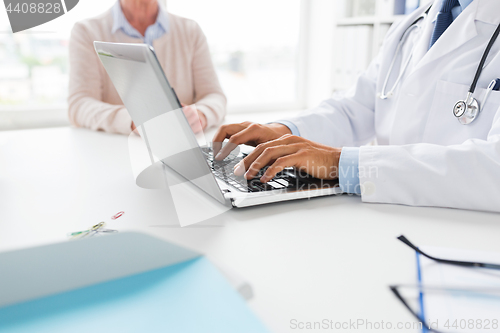 Image of senior woman and doctor with laptop at hospital