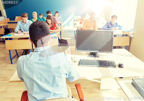 Image of students and teacher with pc computer at school