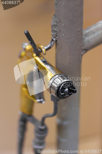 Image of urethane finish or polish sprayer on hanger
