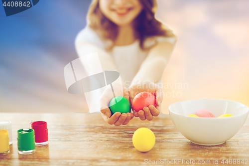 Image of close up of girl holding colored easter eggs