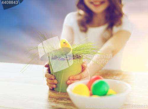 Image of close up of girl with easter toy chicken and eggs