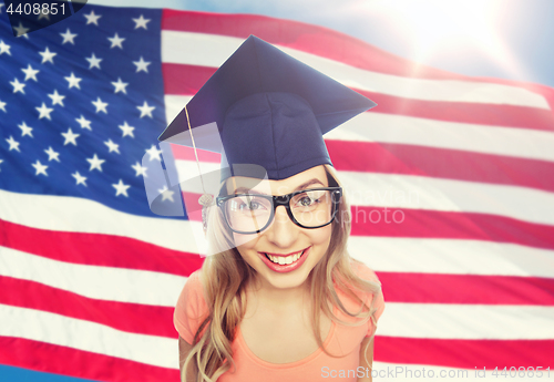 Image of smiling young student woman in mortarboard