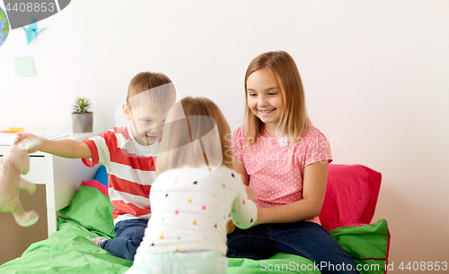 Image of happy kids playing toys at home