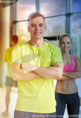 Image of smiling man and woman in gym