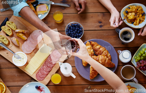 Image of people having breakfast at table with food