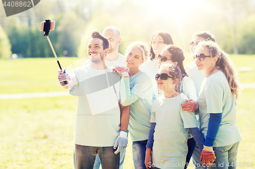 Image of group of volunteers taking smartphone selfie