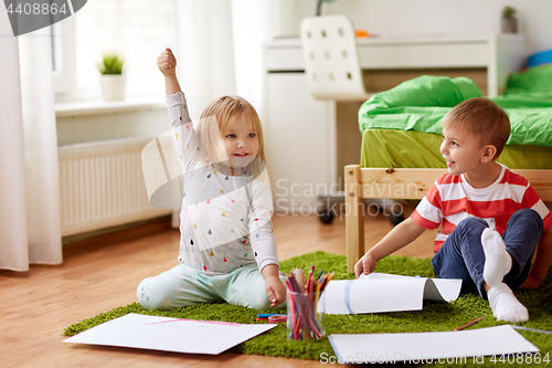 Image of happy kids drawing at home