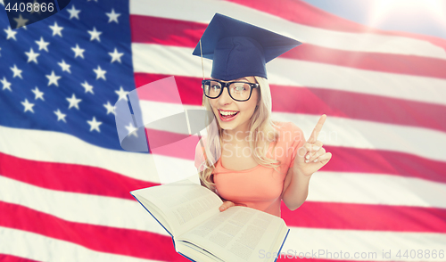 Image of student woman in mortarboard with encyclopedia