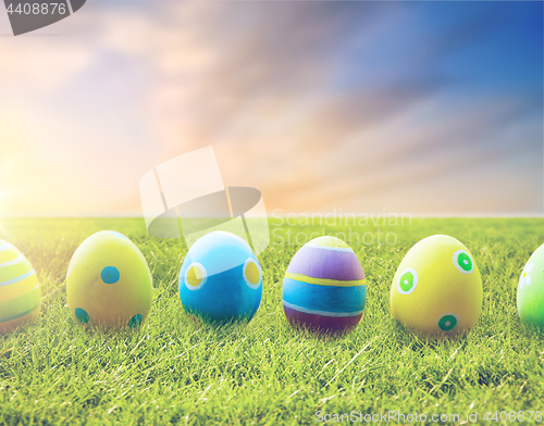 Image of close up of colored easter eggs on grass