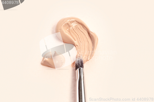 Image of Cosmetic foundation cream and powder with brush