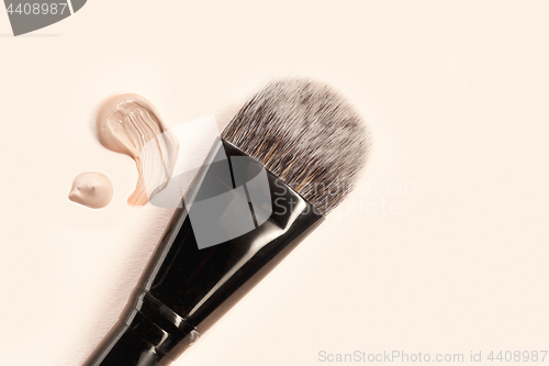 Image of Cosmetic foundation cream and powder with brush