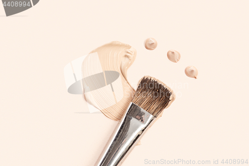 Image of Cosmetic foundation cream and powder with brush