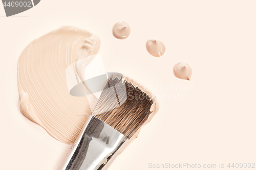 Image of Cosmetic foundation cream and powder with brush