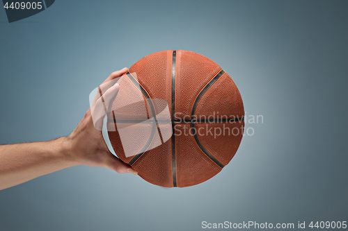 Image of Low key shot of a hand holding a basket ball