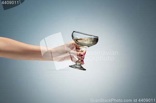 Image of hand holding glass of wine