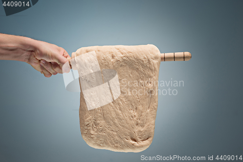 Image of Old man holding a dough.