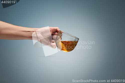 Image of Man holding a cup of coffee