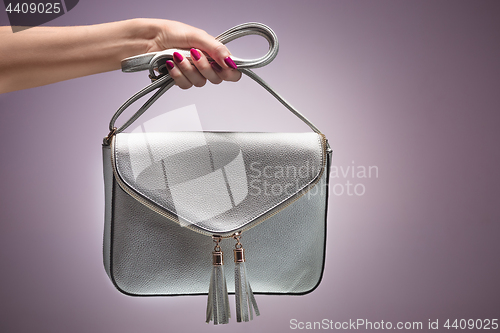 Image of Fashion. Female hand Stylish Trendy Handbag clutch