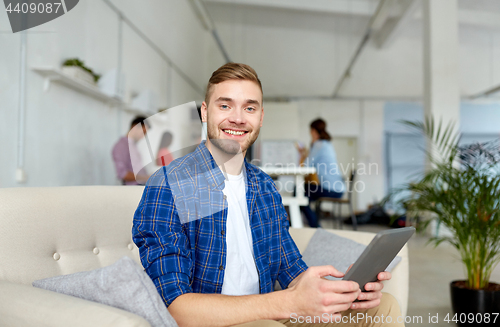 Image of man with tablet pc working at office