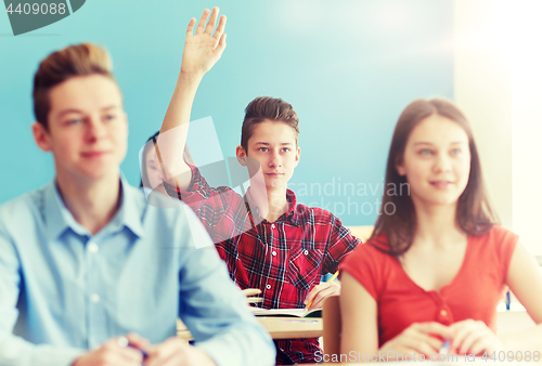 Image of group of students with notebooks at school lesson