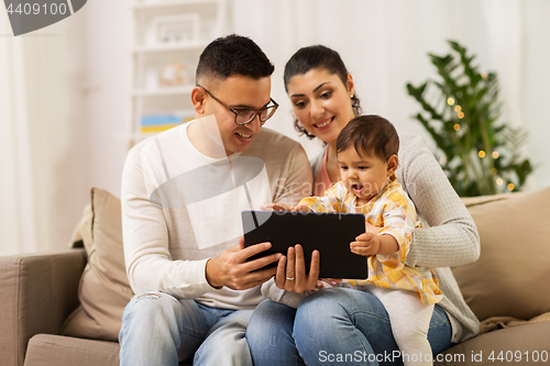 Image of mother, father and baby with tablet pc at home