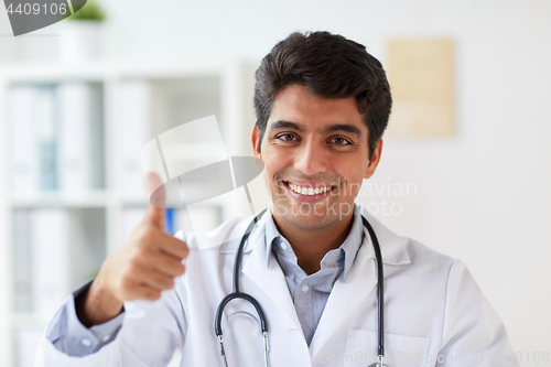 Image of happy doctor at clinic showing thumbs up