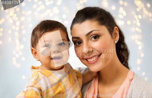 Image of portrait of happy mother with baby daughter