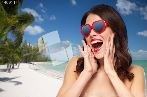 Image of woman with red lipstick and heart shaped shades