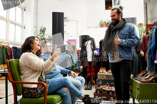 Image of friends choosing clothes at vintage clothing store