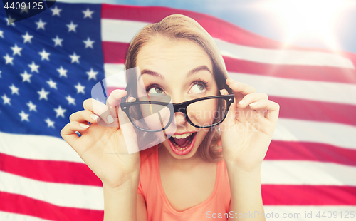 Image of happy young woman or teenage girl in eyeglasses