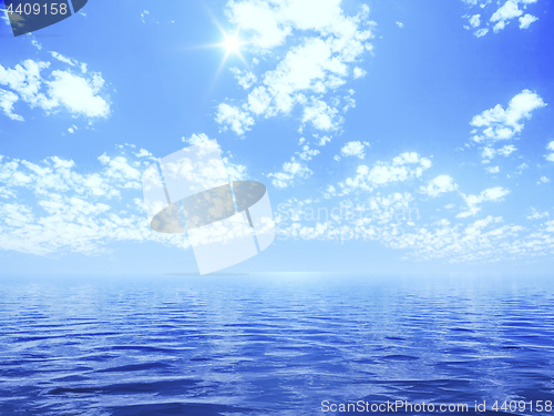 Image of blue sky with some clouds and the sun over the ocean