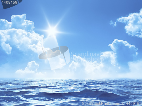 Image of blue sky with some clouds and the sun over the ocean