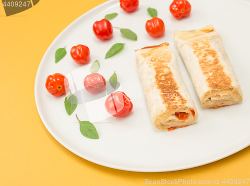 Image of Cooked vegetarian tortillas on yellow background