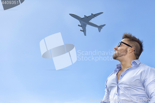 Image of bearded man blue sky airplane