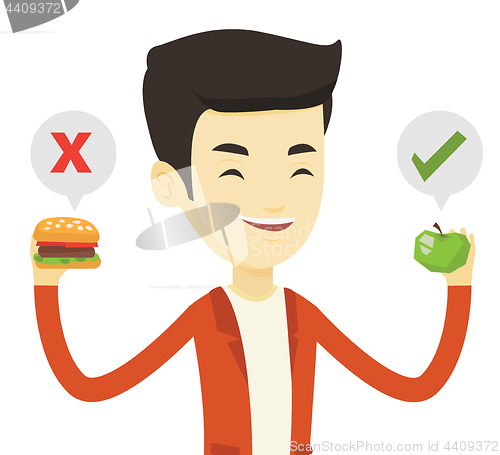 Image of Man choosing between hamburger and cupcake.