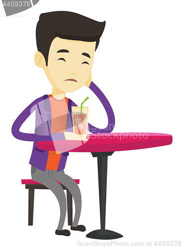 Image of Man drinking cocktail at the bar.