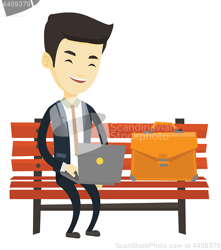 Image of Business man working on laptop outdoor.
