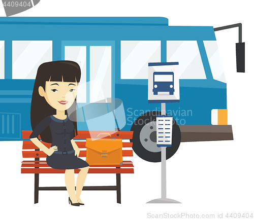 Image of Business woman waiting at the bus stop.