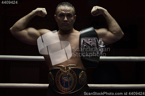 Image of kick boxer with his championship belt