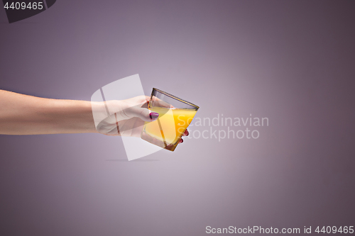 Image of beautiful woman holding orange juice