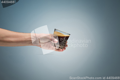 Image of hand holding cup of coffee