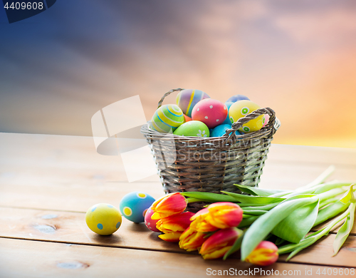 Image of close up of easter eggs in basket and flowers