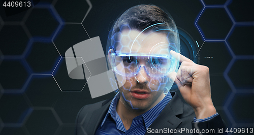 Image of businessman in 3d glasses with virtual hologram