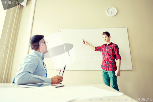 Image of student boy at school white board and teacher