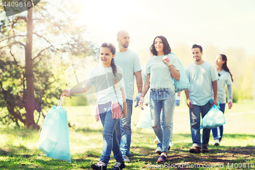 Image of group of volunteers with garbage bags in park