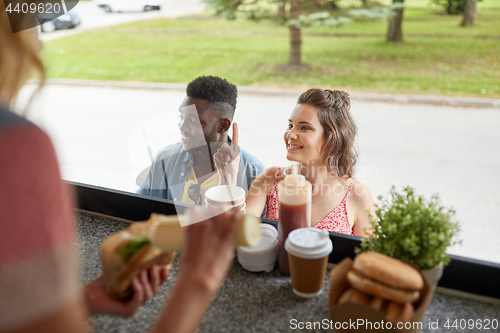 Image of customers couple ordering hamburgers at food truck
