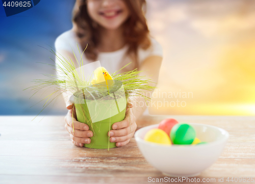 Image of close up of girl with easter toy chicken and eggs