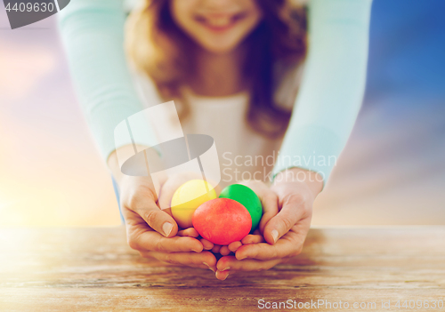 Image of close up of girl and mother holding easter eggs