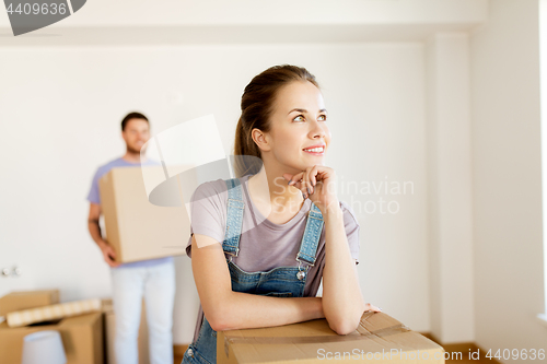 Image of happy couple with boxes moving to new home