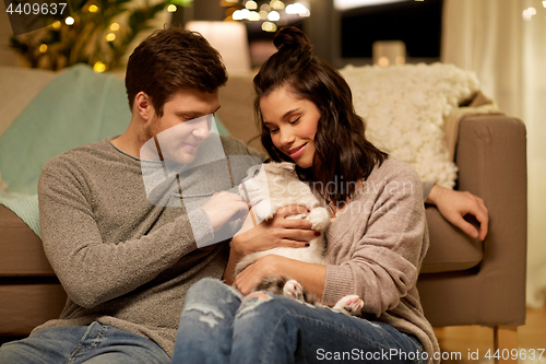 Image of happy couple with cat at home